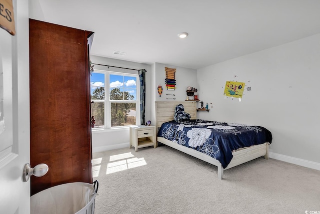 bedroom with baseboards, visible vents, and carpet floors