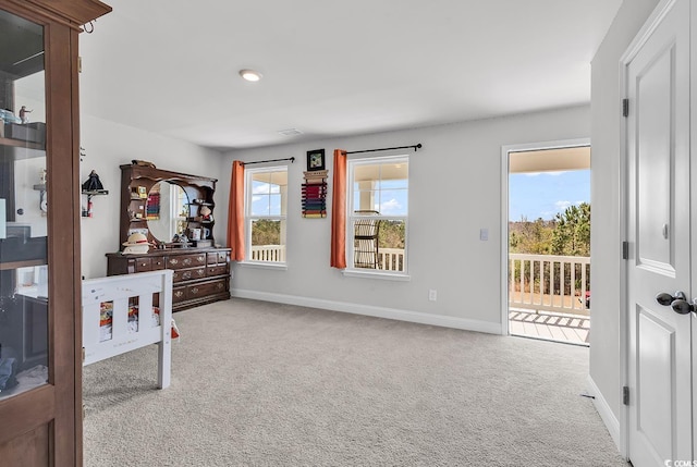 bedroom with baseboards, carpet flooring, and access to outside