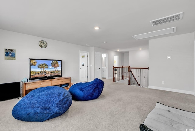 living area featuring visible vents, baseboards, attic access, an upstairs landing, and carpet flooring