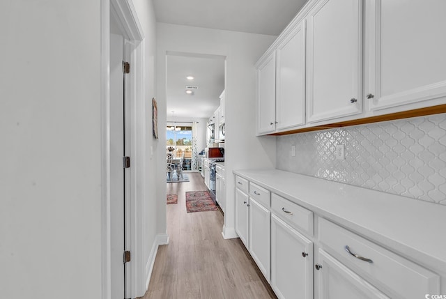 corridor with recessed lighting and light wood-type flooring