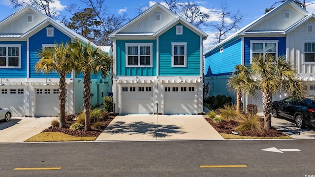 view of front of home with board and batten siding, concrete driveway, and an attached garage