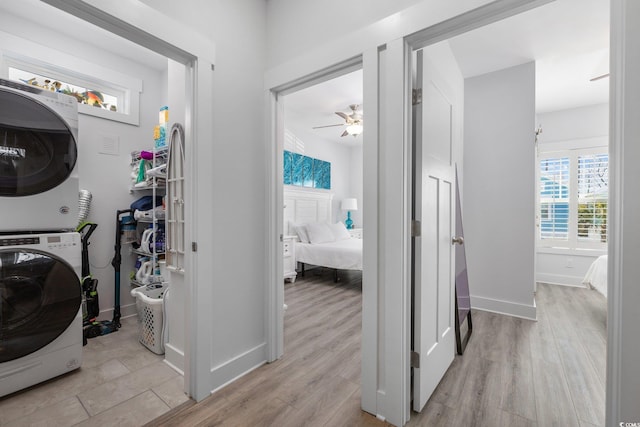 2406 Seabreeze Pl, Myrtle Beach, SC 29577 - laundry area featuring stacked washer and clothes dryer, light wood-style floors, and a ceiling fan