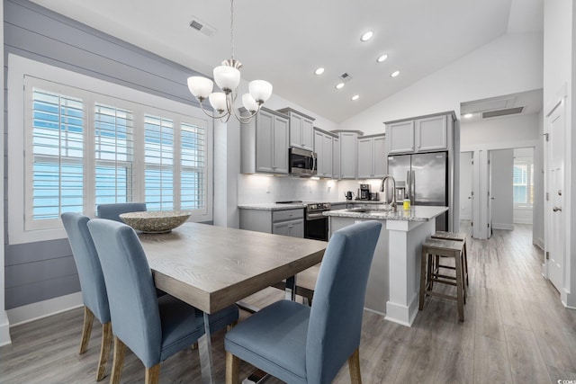 2406 Seabreeze Pl, Myrtle Beach, SC 29577 - dining area featuring recessed lighting, a chandelier, light wood-style flooring, and high vaulted ceiling