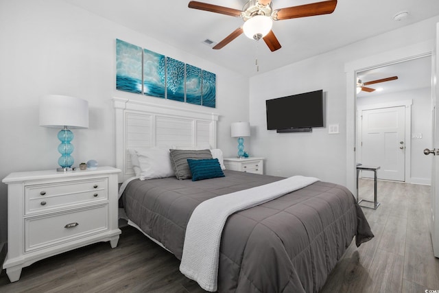 bedroom with visible vents, a ceiling fan, and wood finished floors