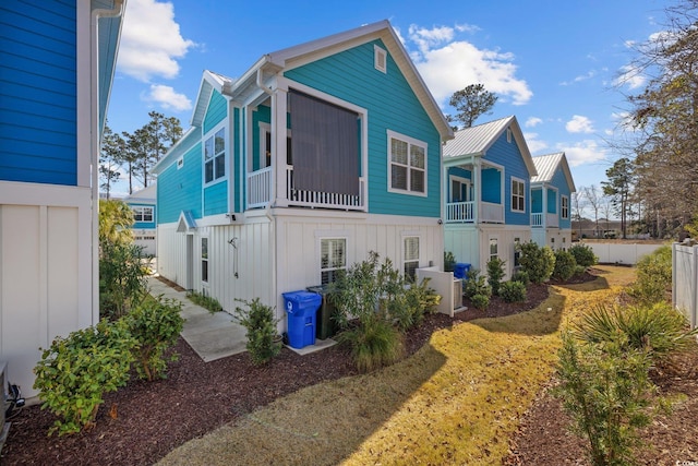 2406 Seabreeze Pl, Myrtle Beach, SC 29577 - back of house with board and batten siding and a metal roof