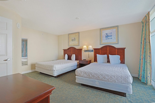 2501 S Ocean Blvd Unit 201, Myrtle Beach, SC 29577 - bedroom featuring carpet floors, baseboards, and a textured ceiling