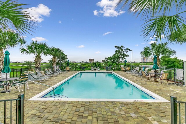 pool featuring a patio and fence