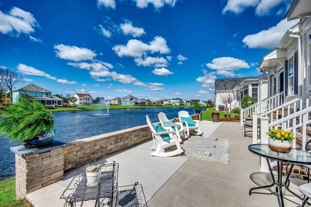 view of patio / terrace with a water view and a residential view