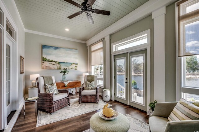 sitting room with a water view, ornamental molding, wood finished floors, french doors, and wood ceiling