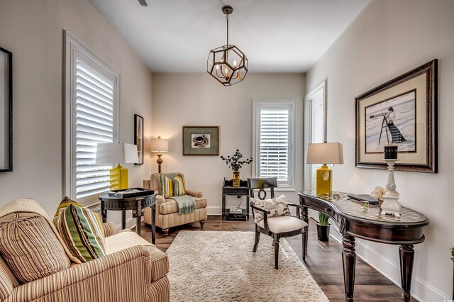 office featuring baseboards, a notable chandelier, and wood finished floors