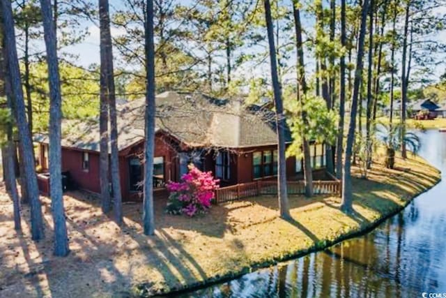 rear view of property with a water view