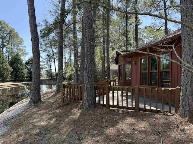 view of yard featuring a deck with water view