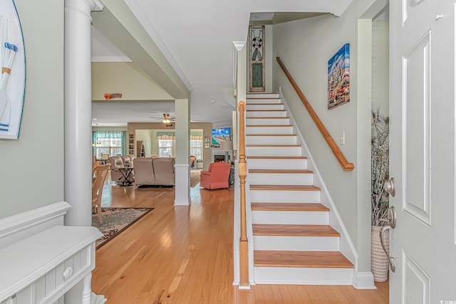 staircase with baseboards, a ceiling fan, and hardwood / wood-style floors