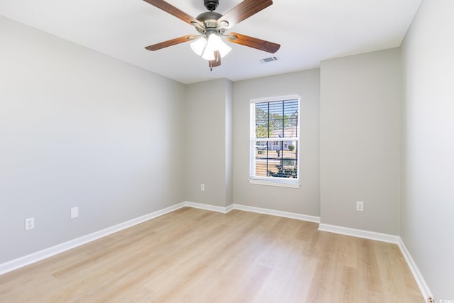 unfurnished room with visible vents, baseboards, light wood-style flooring, and a ceiling fan