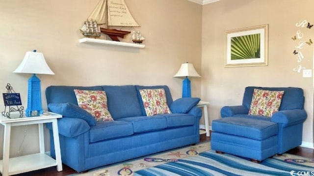 living area with baseboards and wood finished floors