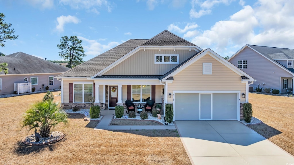 514 Hillsborough Dr, Conway, SC 29526 - craftsman-style home with a porch, concrete driveway, a front lawn, stone siding, and board and batten siding
