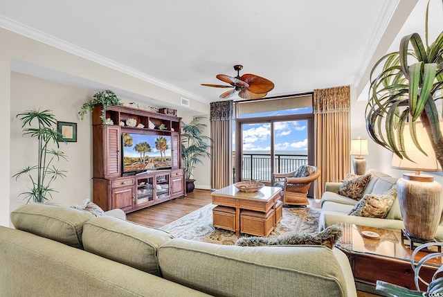 living room featuring ceiling fan, wood finished floors, and ornamental molding