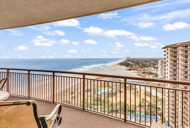 balcony with a beach view and a water view