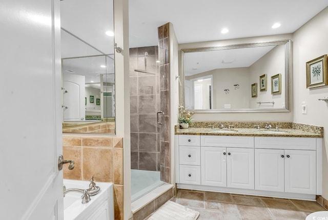 full bath featuring vanity, a bath, recessed lighting, and a stall shower