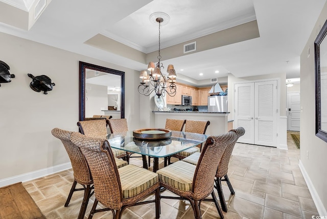 dining area featuring visible vents, a raised ceiling, a notable chandelier, stone tile floors, and baseboards