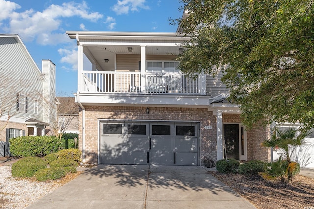 view of front of property featuring brick siding, concrete driveway, and a garage