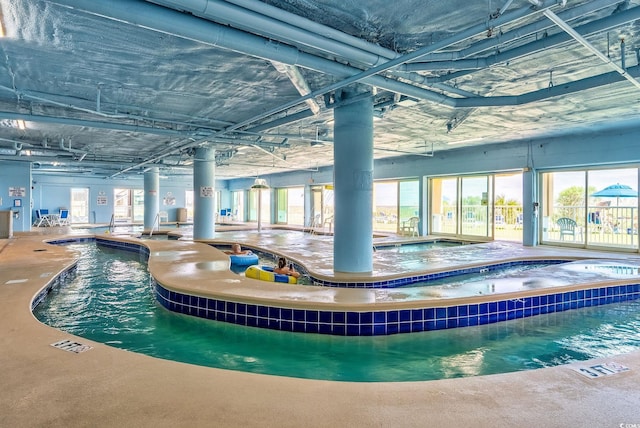 community pool featuring an indoor in ground hot tub