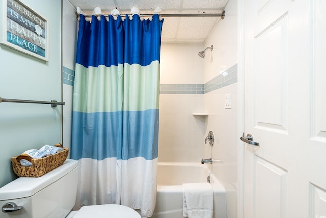 full bathroom featuring a drop ceiling, toilet, and shower / bath combo