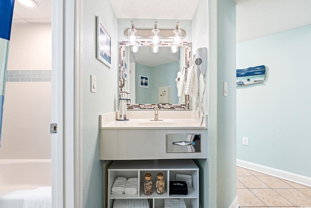 full bathroom featuring tile patterned floors, vanity, a paneled ceiling, and baseboards