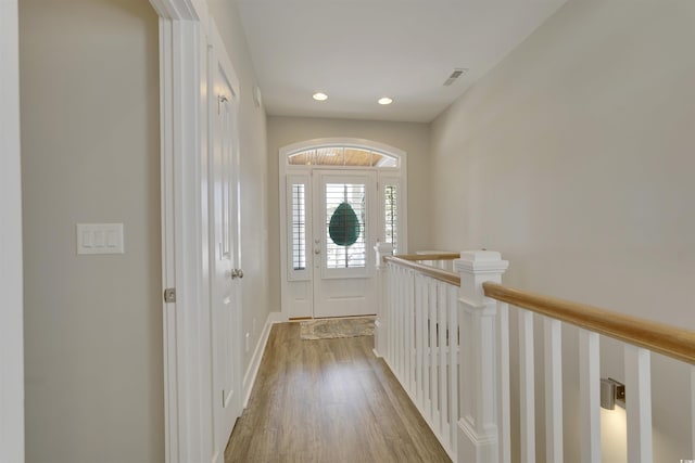 interior space featuring recessed lighting, wood finished floors, visible vents, and baseboards