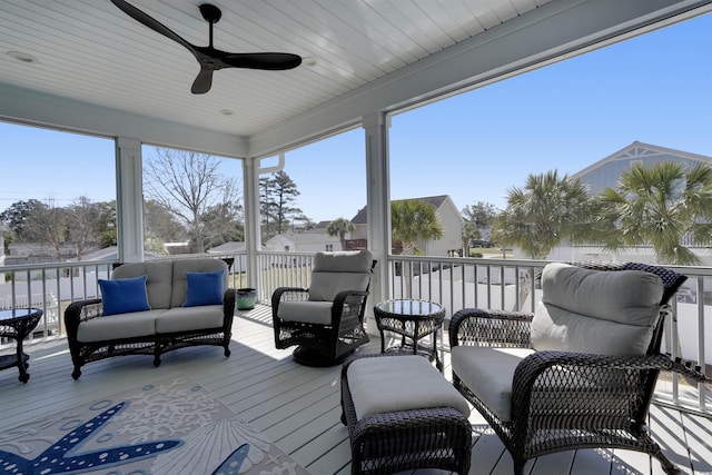 sunroom / solarium with a ceiling fan