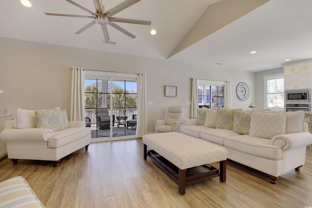 living room featuring visible vents, recessed lighting, lofted ceiling, and light wood-style floors