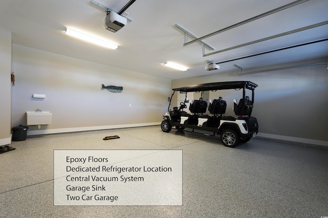 garage featuring a sink, baseboards, and a garage door opener