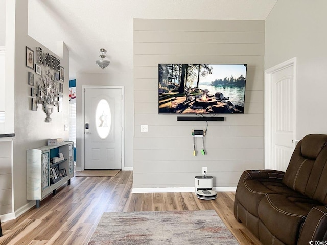 foyer entrance featuring wood finished floors and baseboards