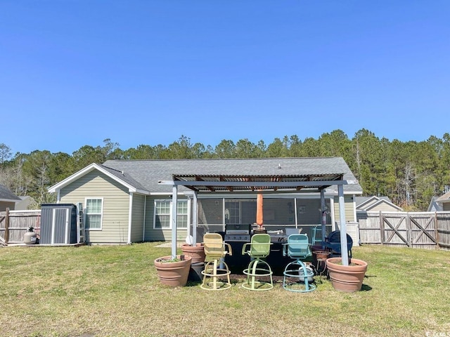 back of house with a yard, fence, and a pergola