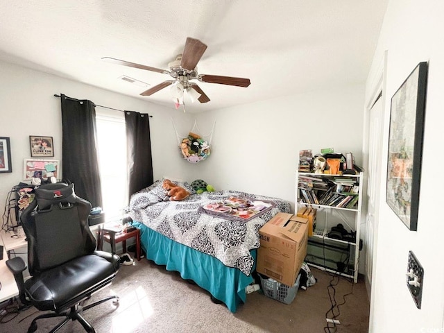 bedroom featuring a ceiling fan, visible vents, and carpet floors