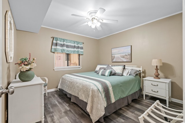 bedroom featuring baseboards, a ceiling fan, dark wood-style flooring, and crown molding