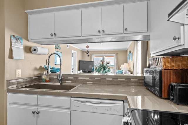 kitchen with electric stove, a sink, range hood, white cabinets, and white dishwasher