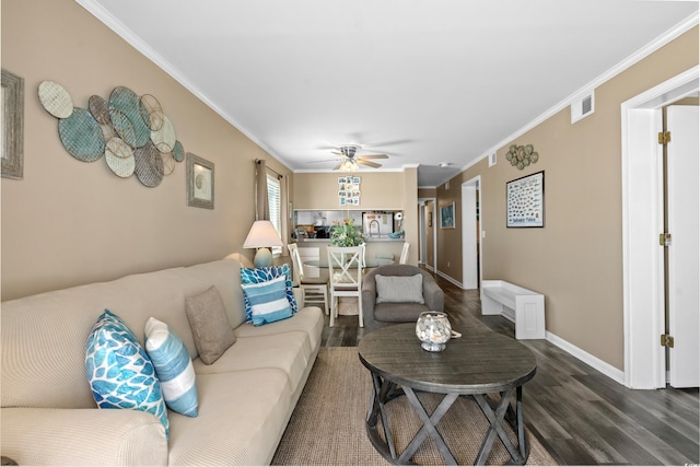 living area featuring baseboards, visible vents, ceiling fan, dark wood-type flooring, and crown molding