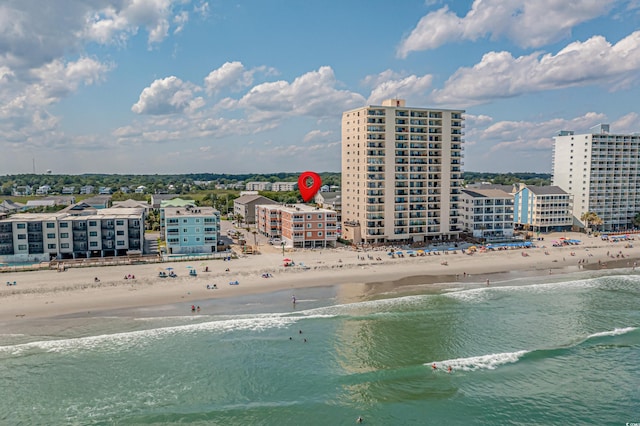 bird's eye view featuring a water view, a view of city, and a beach view