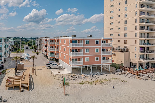 view of building exterior with uncovered parking