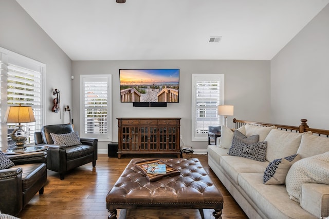 living room featuring visible vents, plenty of natural light, baseboards, and hardwood / wood-style floors