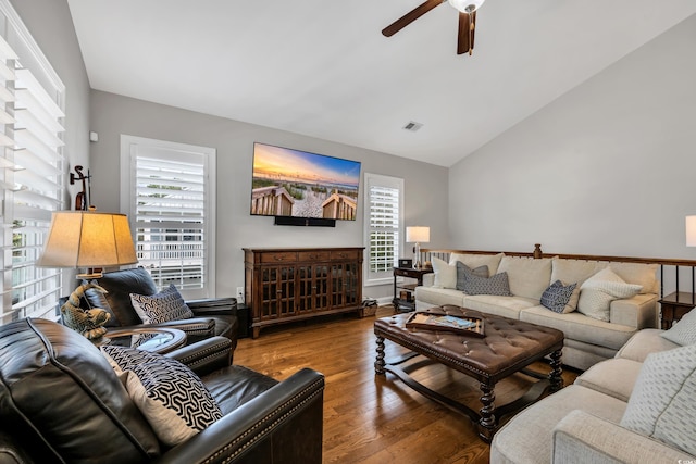 living area with visible vents, wood finished floors, ceiling fan, and vaulted ceiling