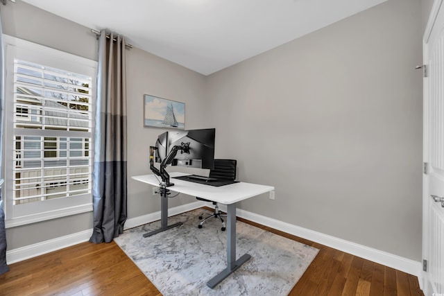 office space with baseboards and wood-type flooring