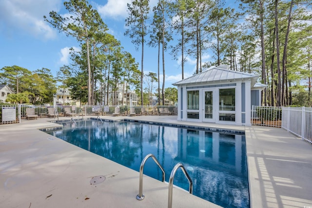 pool featuring a storage structure, an outdoor structure, and fence