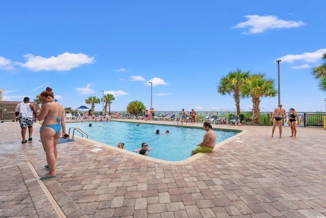 pool featuring a patio and fence