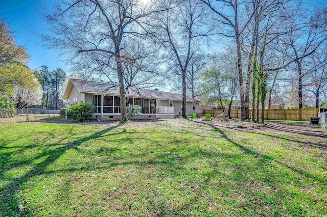 view of yard with a fenced backyard and a sunroom