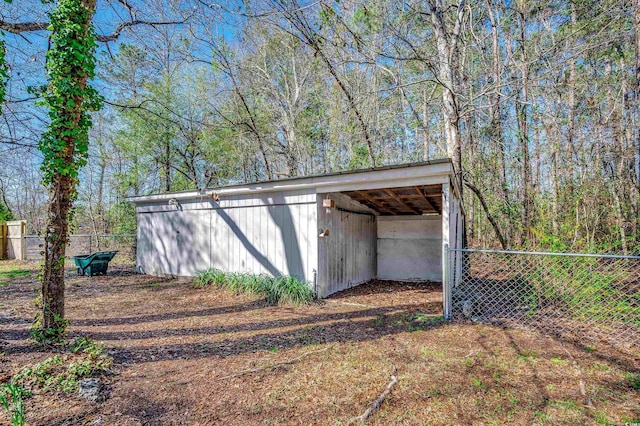 view of pole building with a carport and fence