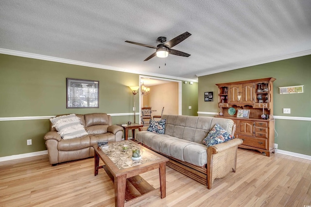 living room with light wood finished floors, baseboards, ornamental molding, ceiling fan with notable chandelier, and a textured ceiling