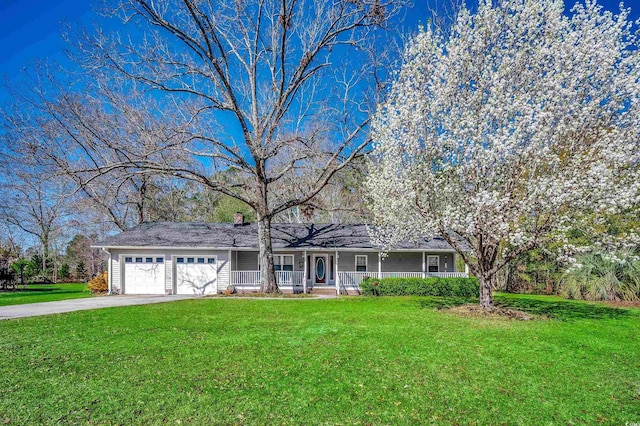 single story home featuring covered porch, an attached garage, concrete driveway, and a front lawn