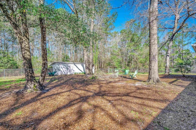 view of yard with a detached garage and fence